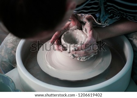 Ceramics. Creation. Clay pots. Handsome master.