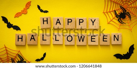 Halloween concept - spiders, bats, web paper crafts on bright background, top view