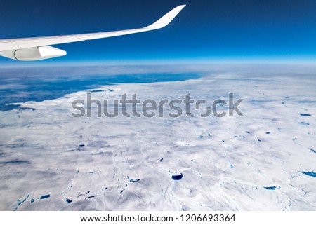 Greenland View on Airplane,Frozen Mountains Above,Glaciers Greenland
top view greenland, Wing aircraft in altitude during flight,Aircraft wing on Greenland 