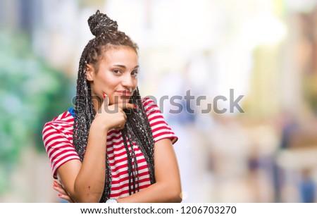 Young braided hair african american girl over isolated background looking confident at the camera with smile with crossed arms and hand raised on chin. Thinking positive.