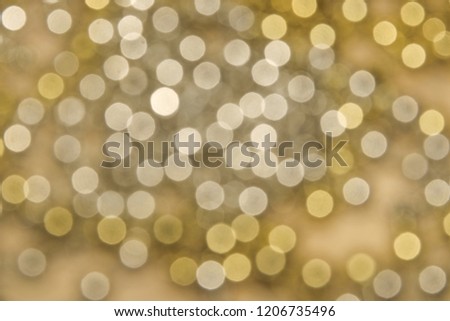 Abstract background with many golden sparkle bokeh rounds closeup defocused effect fun celebrate eve