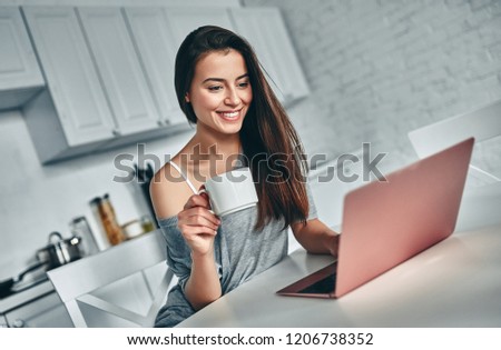 Good morning! Attractive young woman is having rest at home. Girl on kitchen.
