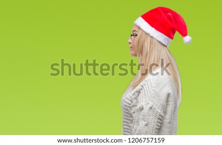 Young caucasian woman wearing christmas hat over isolated background looking to side, relax profile pose with natural face with confident smile.
