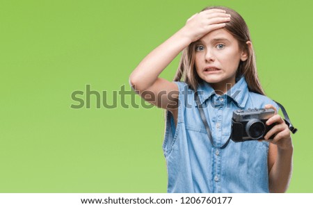 Young beautiful girl taking photos using vintage camera over isolated background stressed with hand on head, shocked with shame and surprise face, angry and frustrated. Fear and upset for mistake.