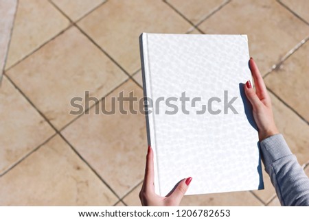 White book in hand