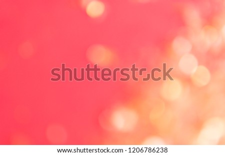 Golden bokeh lights on a red background, shallow depth. Perfect for party invitation or festive background. Copy space for text