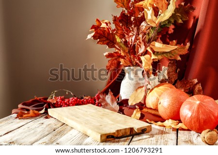 Autumn composition on a wooden table in the sharp morning light