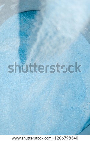 blue powder soap with the powder being knocked out of focus