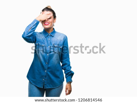 Young beautiful woman over isolated background smiling and laughing with hand on face covering eyes for surprise. Blind concept.