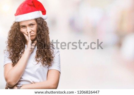 Young brunette girl wearing christmas hat over isolated background thinking looking tired and bored with depression problems with crossed arms.