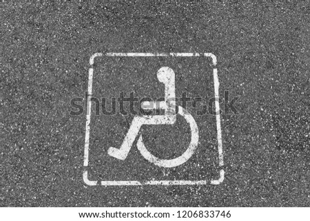 Handicapped parking sign on asphalt 