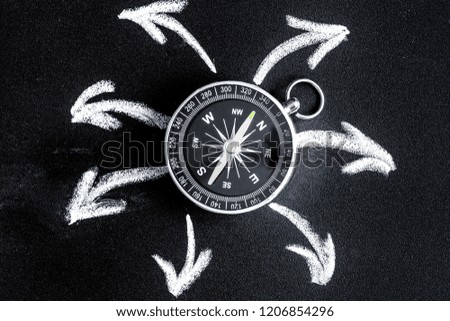 compass on dark background concept - arrows, direction top view