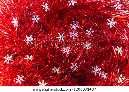 Christmas and New Year abstract festive background of red tinsel and snowflakes.