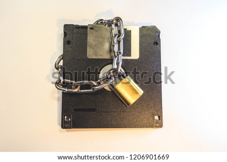 The diskette is protected by a lock with a chain.