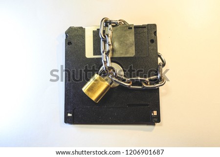 The diskette is protected by a lock with a chain.