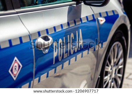 Police car on patrol with the police sign on the door.  Royalty-Free Stock Photo #1206907717