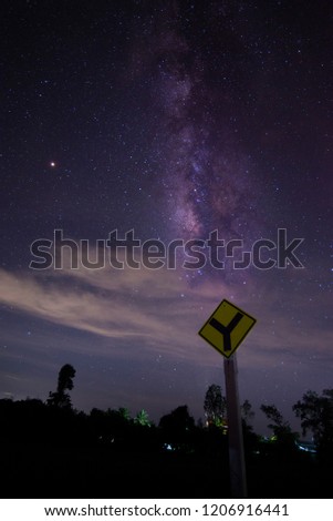 Milky way galaxy look up vertically, The front is a traffic sign and seems to be similar.