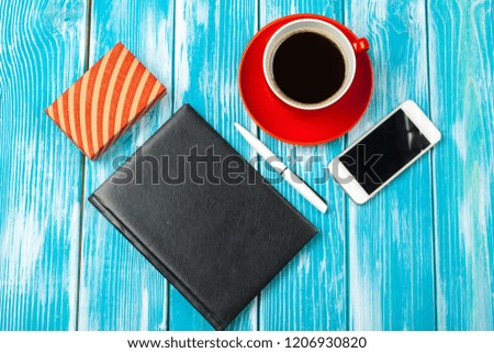Modern workplace with cup of coffee on wooden table