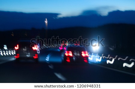 Abstract. Grain. Blurred. Night road and low speed shutter light at highway