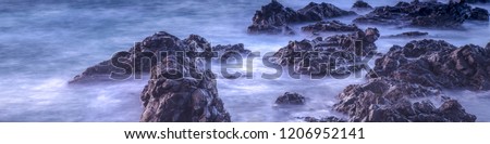 Water with rock nature photo with long exposure fog effect.Panorama or banner abstract color ocean background