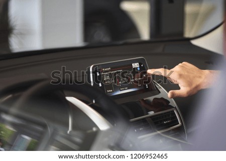 Modern media display in the interior of the car. The screen with multimedia shows fuel consumption. Concept for car rental