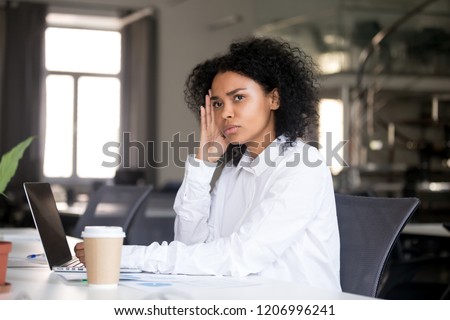 Serious thoughtful african business woman sitting at office desk with laptop looking away thinking of problem solution, pensive millennial black female searching new idea at work lost in thoughts Royalty-Free Stock Photo #1206996241