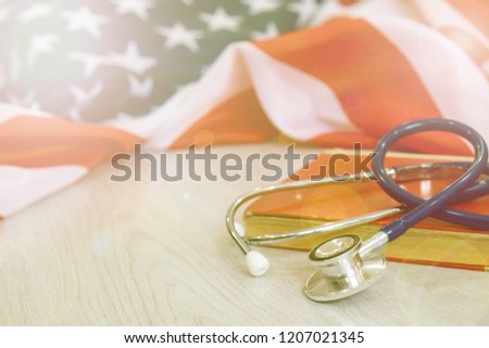 stethoscope on the background of the USA flag. health insurance scheme. national health programme