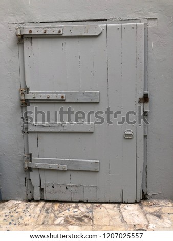 An old wooden grey door in Mazatlán-Mexico 