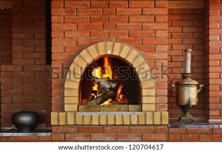 Russian interior kitchen with an oven and a burning fire Royalty-Free Stock Photo #120704617