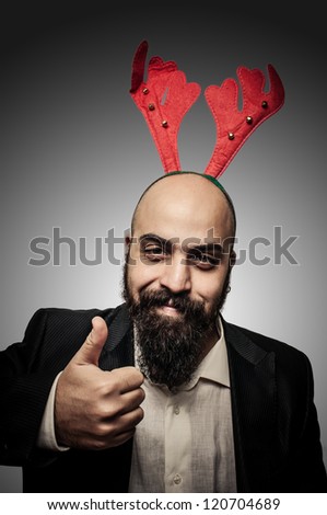 positive christmas bearded man with funny expressions on grey background