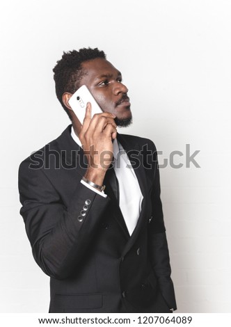 Close up portrait of afro american man looking at his mobile phone. business negotiations by phone