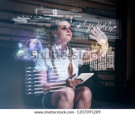 Young woman using tablet and infograph screen at home.Futuristic user interface.