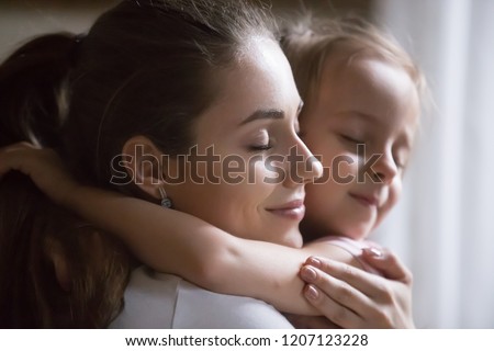 Close up portrait young beautiful sincere woman mother embrace hug little preschool girl daughter make peace after quarrel. Happy motherhood, custody guardianship new mother for adopted child concept Royalty-Free Stock Photo #1207123228