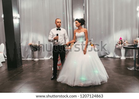 Groom in black suit and bride in white dress