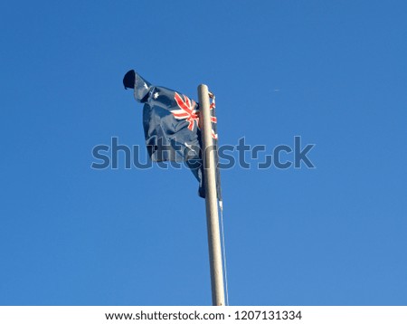 australia flag waving on the blue sky background
