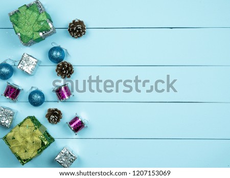 Gifts and accessories decorate on light green wooden background for happy new year.