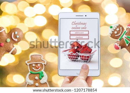 Christmas online sale. Tablet for buying gifts online on a Christmas background. My idea and artwork.