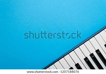 Abstract light-blue background with piano in the right corner 