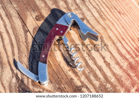 Wine bottle opener on wooden background with copy space