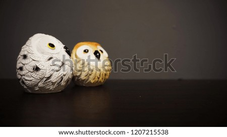                      Wooden Owl Toys with Dark Old Grey Wall Background          