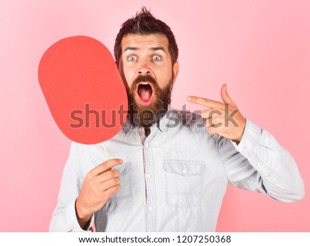 Surprised bearded man hold red name plate.  