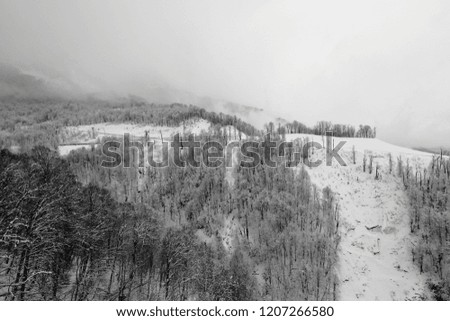 Black-and-white photographs of ski slopes and lifts in winter the snowy slopes of the mountains during a snowfall