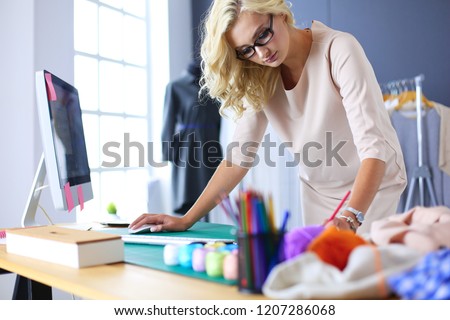 Fashion designer woman working on her designs in the studio.