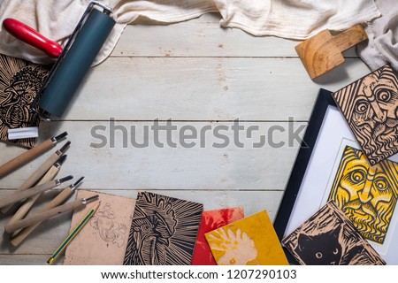 Top view flat lay of Printmaking tools for woodcut relief print arranged to form a picture frame