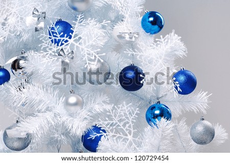 Closeup photo of white decorated christmas tree branch