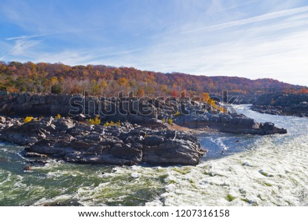 Potomac River rapids in Great Falls state park in autumn, Virginia, USA. Kayaking adventure on the river in fall.