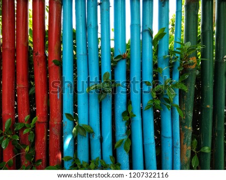 The house's fence is made of colorful bamboo of the countryside in low light