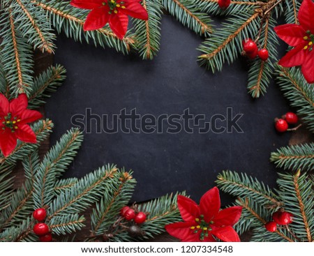 Christmas background with tree branches and cones on a wooden background. Top view, copy space. 