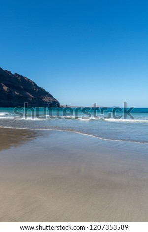 Natural yellow sandy beach in village Orzola, north of Lanzarote, Canary islands, Spain in winter
