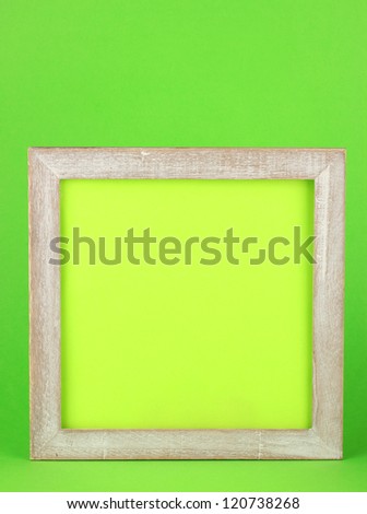 wooden frame on color background